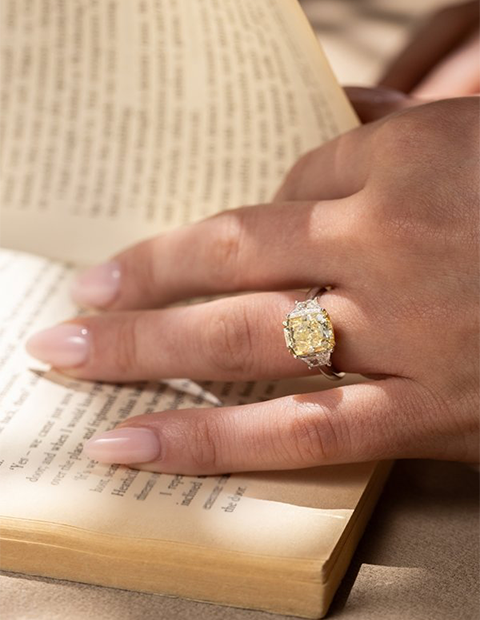 Pair of hands held with an engagement ring on one 